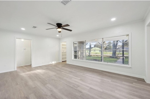 unfurnished room featuring baseboards, visible vents, wood finished floors, and recessed lighting