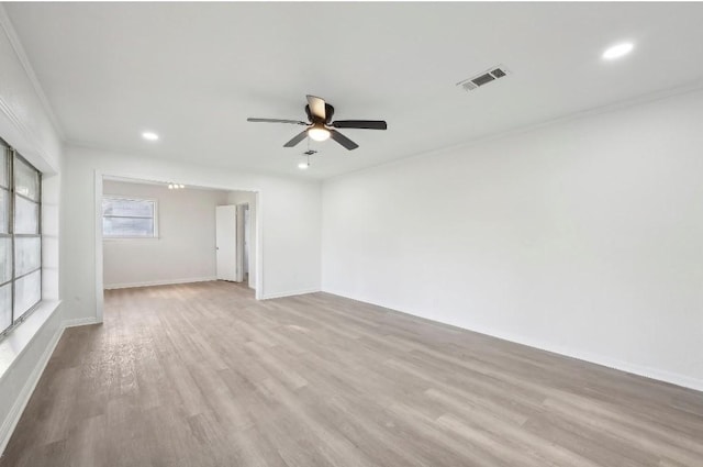 empty room with recessed lighting, visible vents, ornamental molding, ceiling fan, and wood finished floors