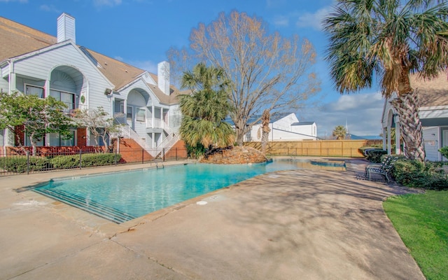 view of swimming pool with a patio, fence, and a fenced in pool