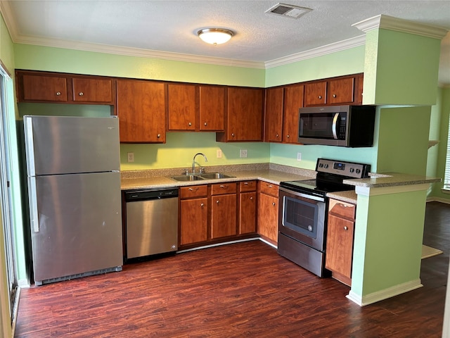 kitchen featuring appliances with stainless steel finishes, dark wood finished floors, visible vents, and a sink