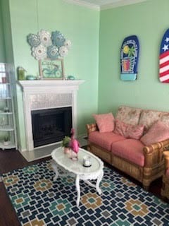 3506 Cove View Blvd Unit 1506, Galveston, TX 77554 - living room featuring crown molding and a high end fireplace
