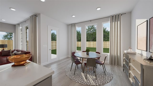 dining area with light wood-style flooring, baseboards, and recessed lighting