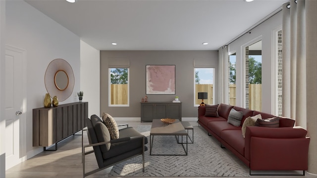 living area featuring baseboards, light wood finished floors, recessed lighting, and a healthy amount of sunlight