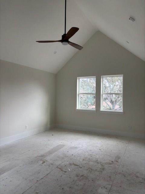 empty room with a ceiling fan, high vaulted ceiling, and baseboards