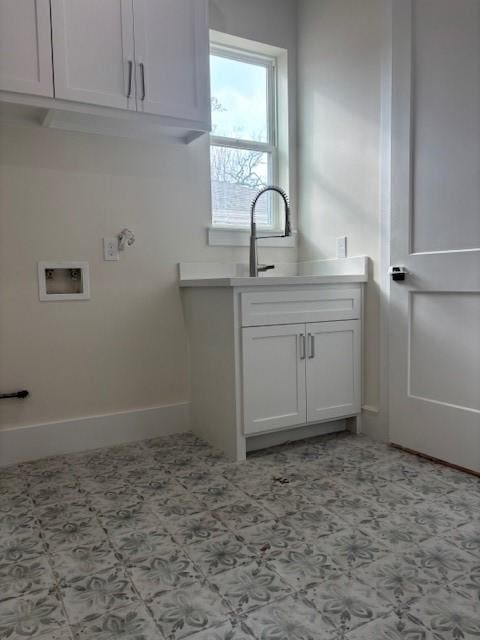 washroom with hookup for a washing machine and baseboards