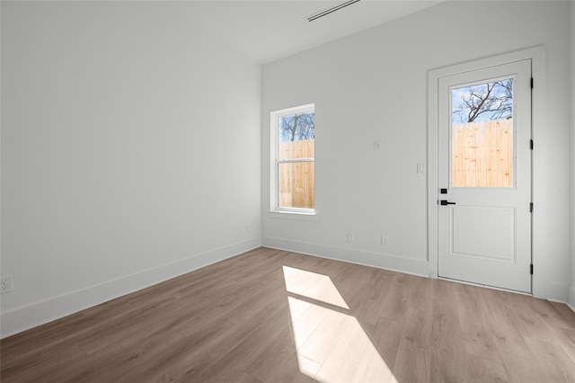 entrance foyer featuring light wood finished floors and baseboards