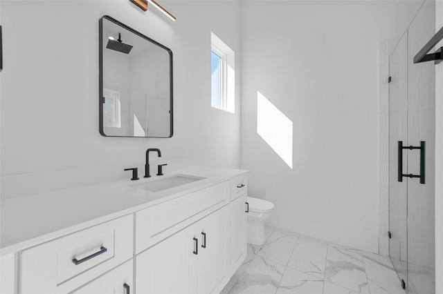 full bath featuring a stall shower, marble finish floor, vanity, and toilet