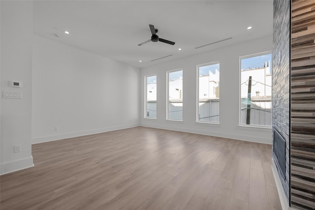 unfurnished living room featuring recessed lighting, stairway, a ceiling fan, light wood-type flooring, and baseboards