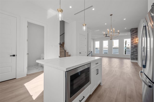 kitchen featuring pendant lighting, appliances with stainless steel finishes, white cabinetry, and recessed lighting