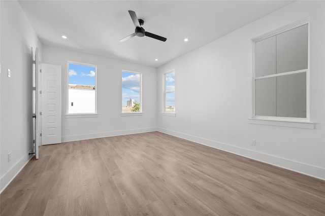 spare room with ceiling fan, light wood finished floors, recessed lighting, and baseboards