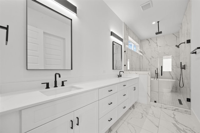 full bathroom with marble finish floor, a sink, a marble finish shower, and double vanity