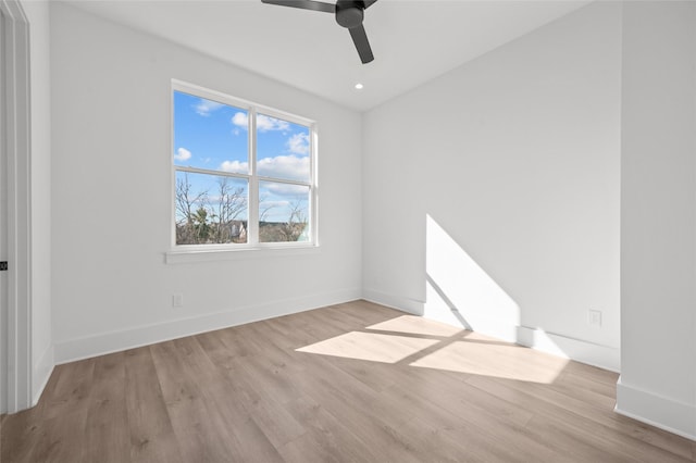 empty room with a ceiling fan, baseboards, wood finished floors, and recessed lighting