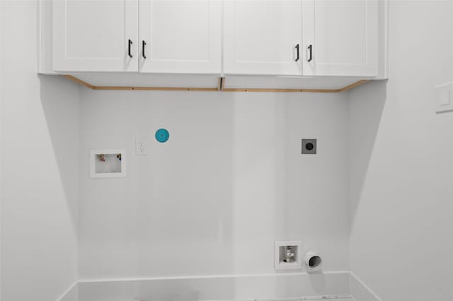 laundry area featuring cabinet space, hookup for a washing machine, electric dryer hookup, and baseboards