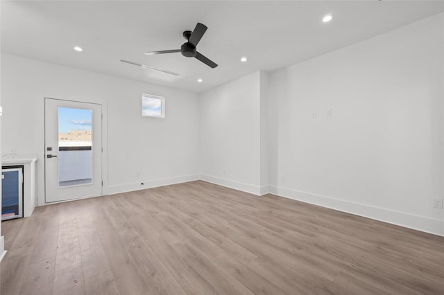 unfurnished living room featuring baseboards, light wood finished floors, and recessed lighting