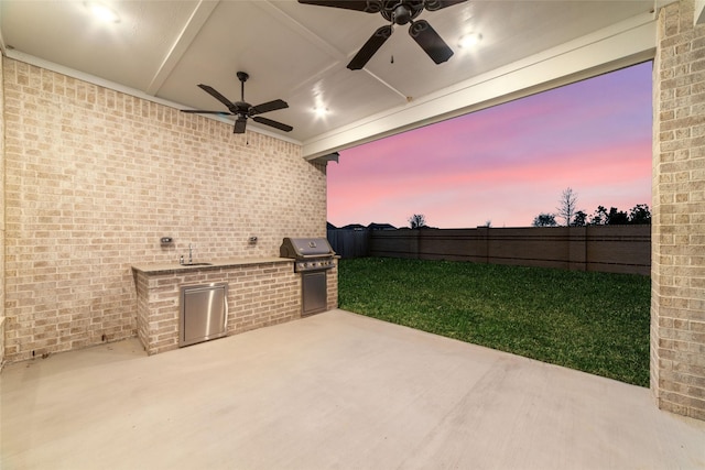 view of patio / terrace with a ceiling fan, area for grilling, a fenced backyard, grilling area, and a sink