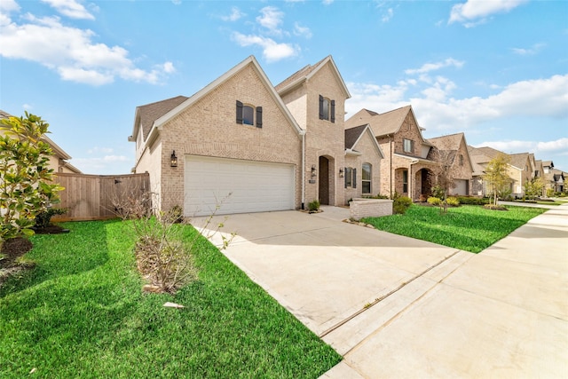 view of front of property with concrete driveway, brick siding, a front lawn, and fence