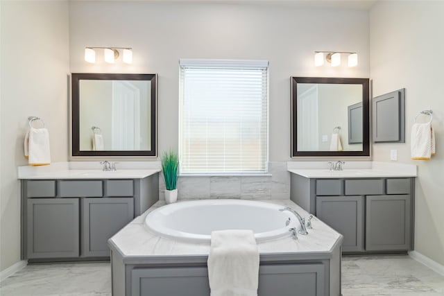 bathroom with marble finish floor, two vanities, and a sink