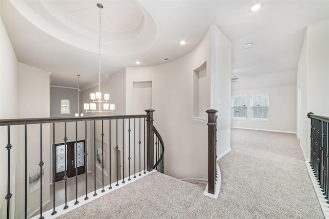 corridor with carpet floors, a notable chandelier, recessed lighting, an upstairs landing, and baseboards