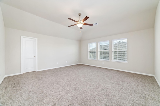 unfurnished room featuring carpet floors, ceiling fan, visible vents, and vaulted ceiling