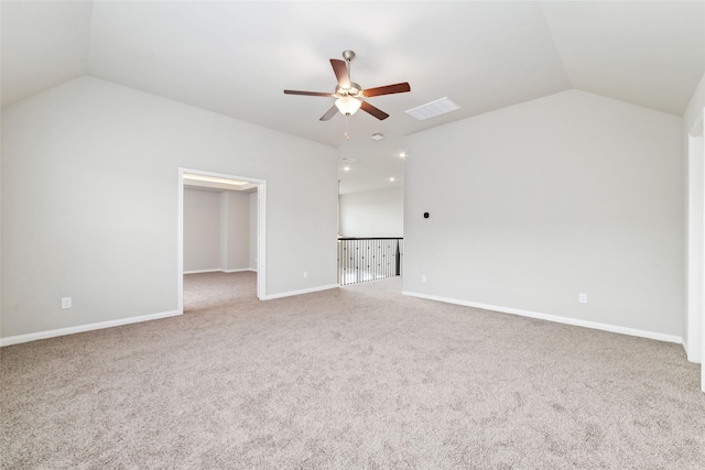 unfurnished living room with a ceiling fan, visible vents, vaulted ceiling, baseboards, and carpet