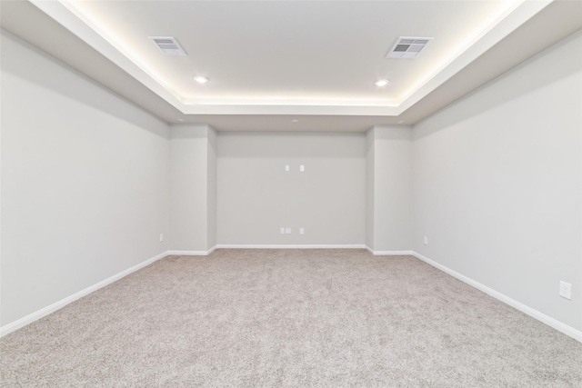 unfurnished room with carpet floors, recessed lighting, visible vents, and baseboards