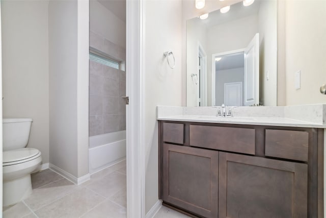 bathroom with toilet, tile patterned flooring, baseboards, and vanity