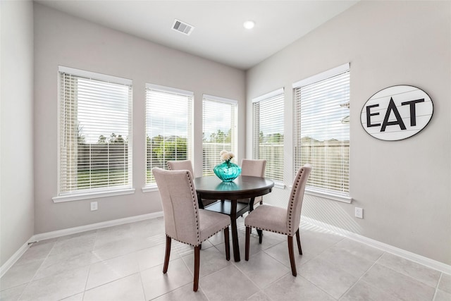 dining space with visible vents, baseboards, and light tile patterned floors