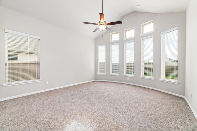 spare room with a healthy amount of sunlight, carpet, baseboards, and ceiling fan