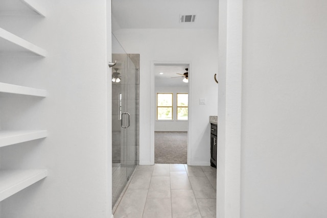 bathroom featuring tile patterned floors, visible vents, a stall shower, and vanity