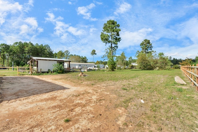 view of yard with an outdoor structure and fence