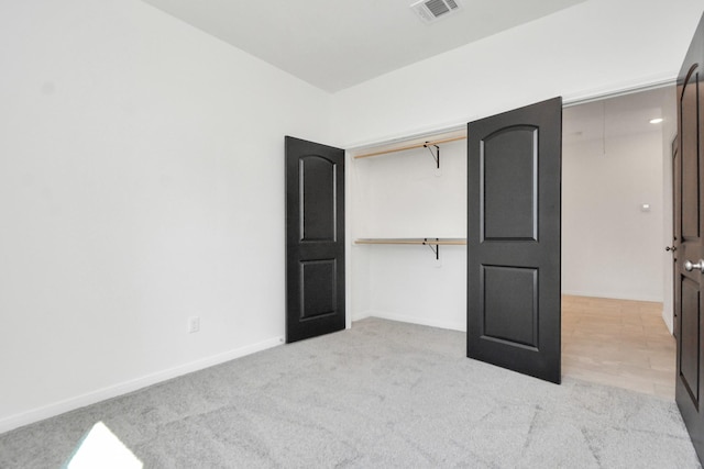 unfurnished bedroom with visible vents, carpet floors, and baseboards