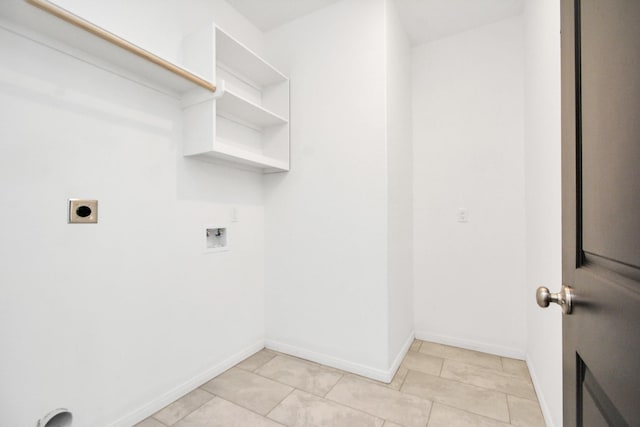 laundry area featuring baseboards, light tile patterned floors, laundry area, hookup for a washing machine, and electric dryer hookup