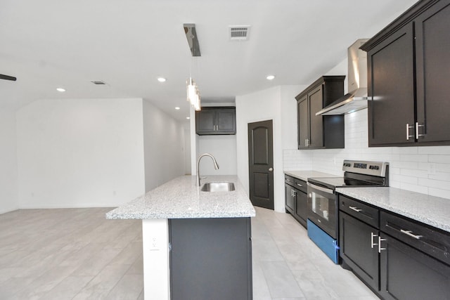 kitchen featuring visible vents, stainless steel electric range oven, decorative backsplash, wall chimney exhaust hood, and a sink