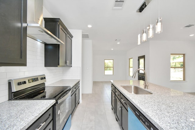 kitchen with electric range, visible vents, wall chimney range hood, and a sink