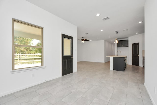 unfurnished room featuring a ceiling fan, baseboards, visible vents, recessed lighting, and a sink