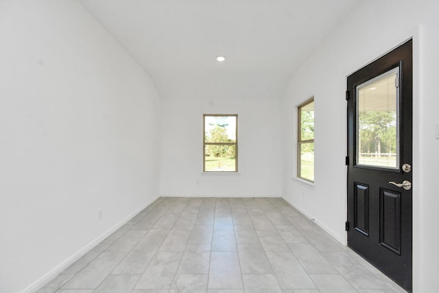 spare room with recessed lighting and baseboards