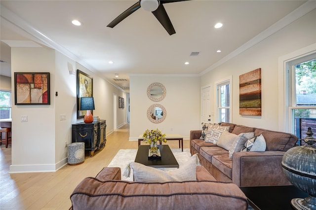 living area featuring light wood-type flooring, visible vents, crown molding, and recessed lighting