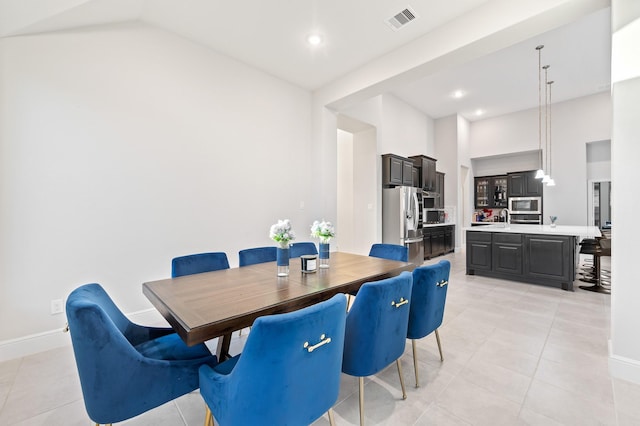 dining area with light tile patterned floors, visible vents, and baseboards