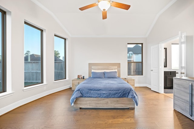 bedroom with light wood-style floors, ornamental molding, and vaulted ceiling