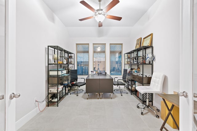 office featuring tile patterned flooring, vaulted ceiling, ceiling fan, and baseboards