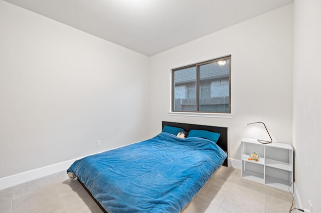 bedroom featuring baseboards and tile patterned floors