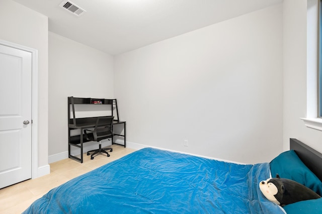 bedroom with tile patterned flooring, visible vents, and baseboards