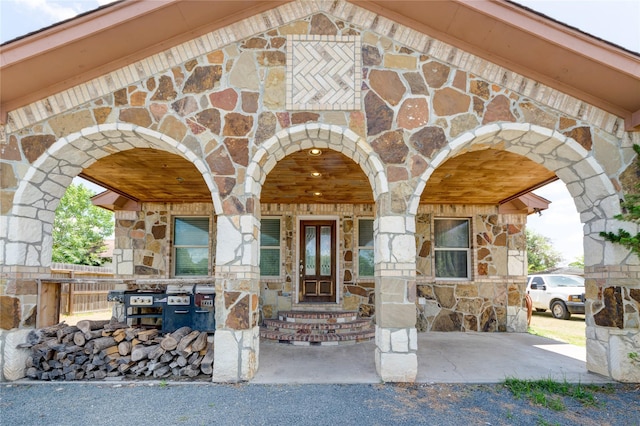 property entrance featuring stone siding and brick siding