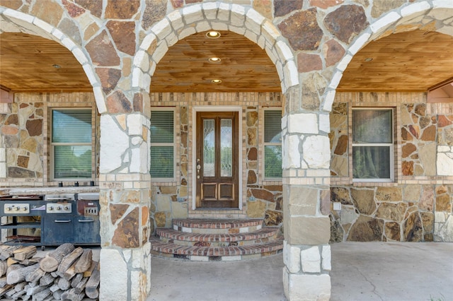 doorway to property with stone siding