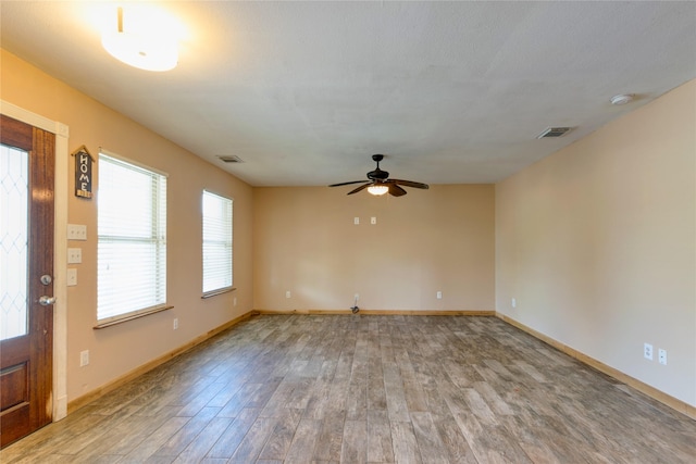 interior space featuring visible vents, baseboards, and wood finished floors