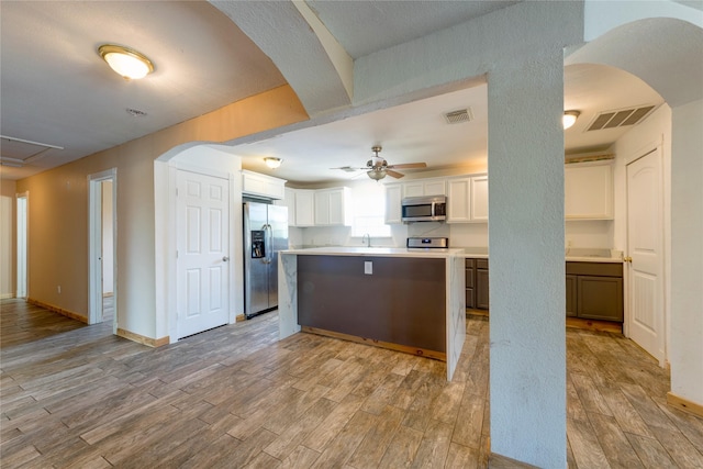 kitchen featuring light wood finished floors, visible vents, and stainless steel appliances