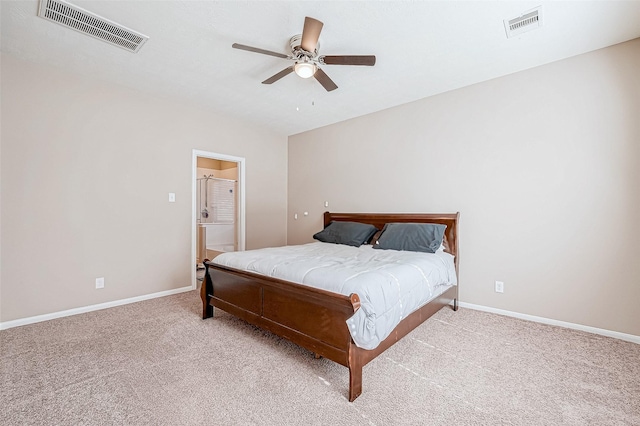 carpeted bedroom featuring a ceiling fan, visible vents, connected bathroom, and baseboards