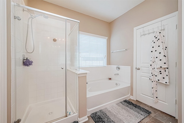 full bathroom featuring a stall shower, tile patterned flooring, and a bath