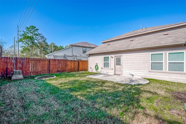 back of property featuring a yard, a patio area, and fence