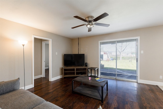 living area with a ceiling fan, baseboards, and wood finished floors